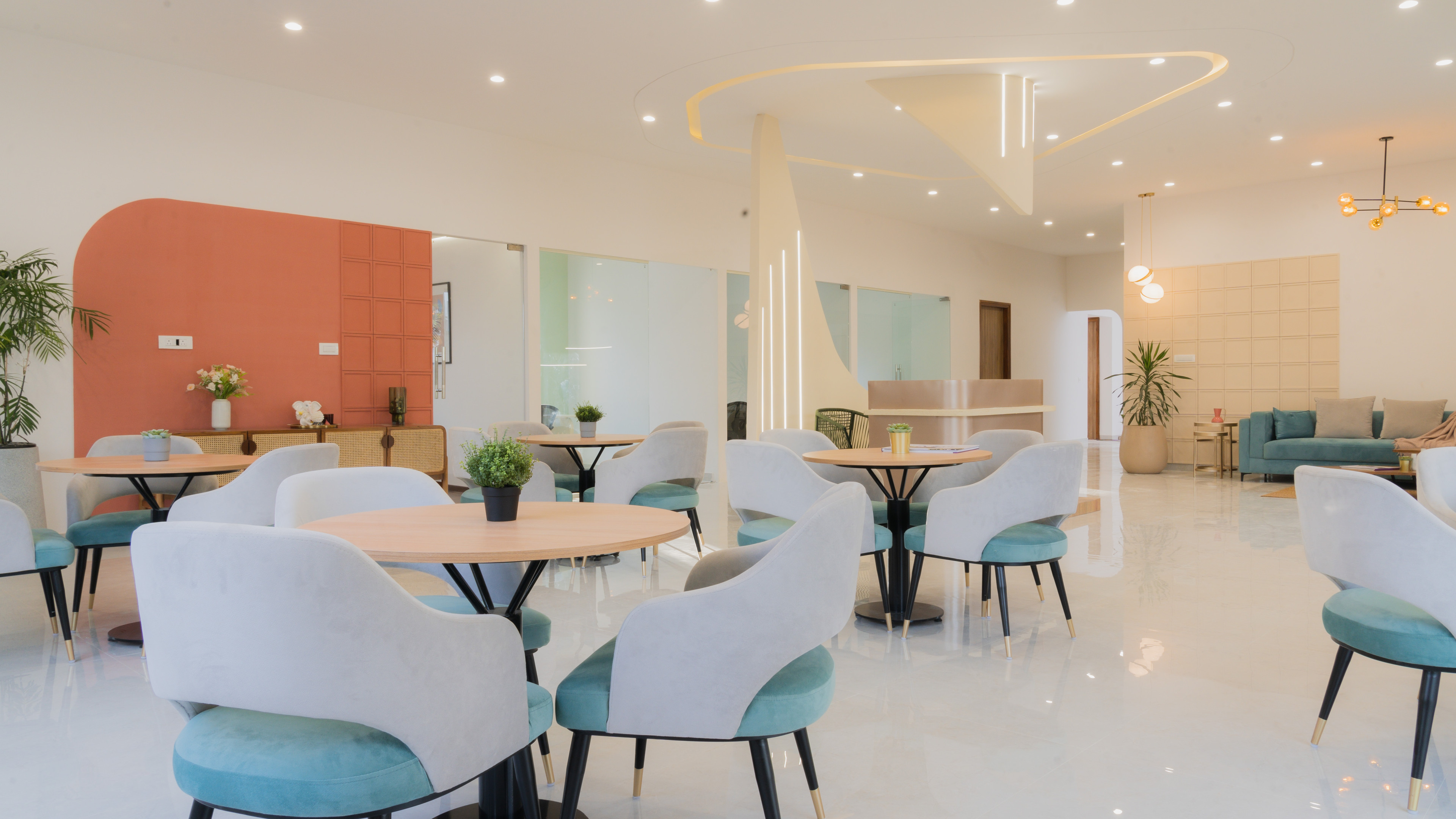 An open café-lounge in soft, sculptural tones
