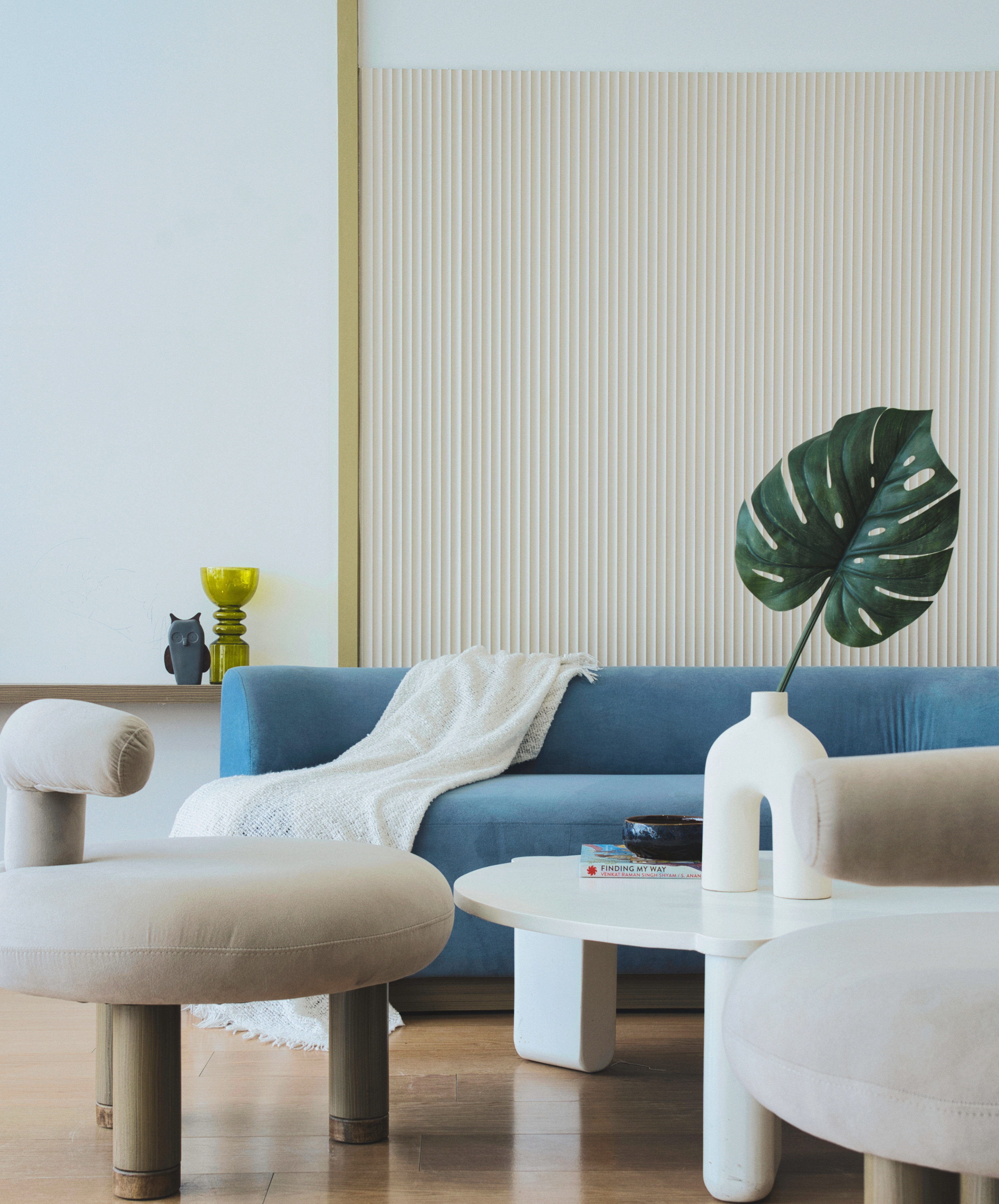 A lounge in soft blues and sculptural seating