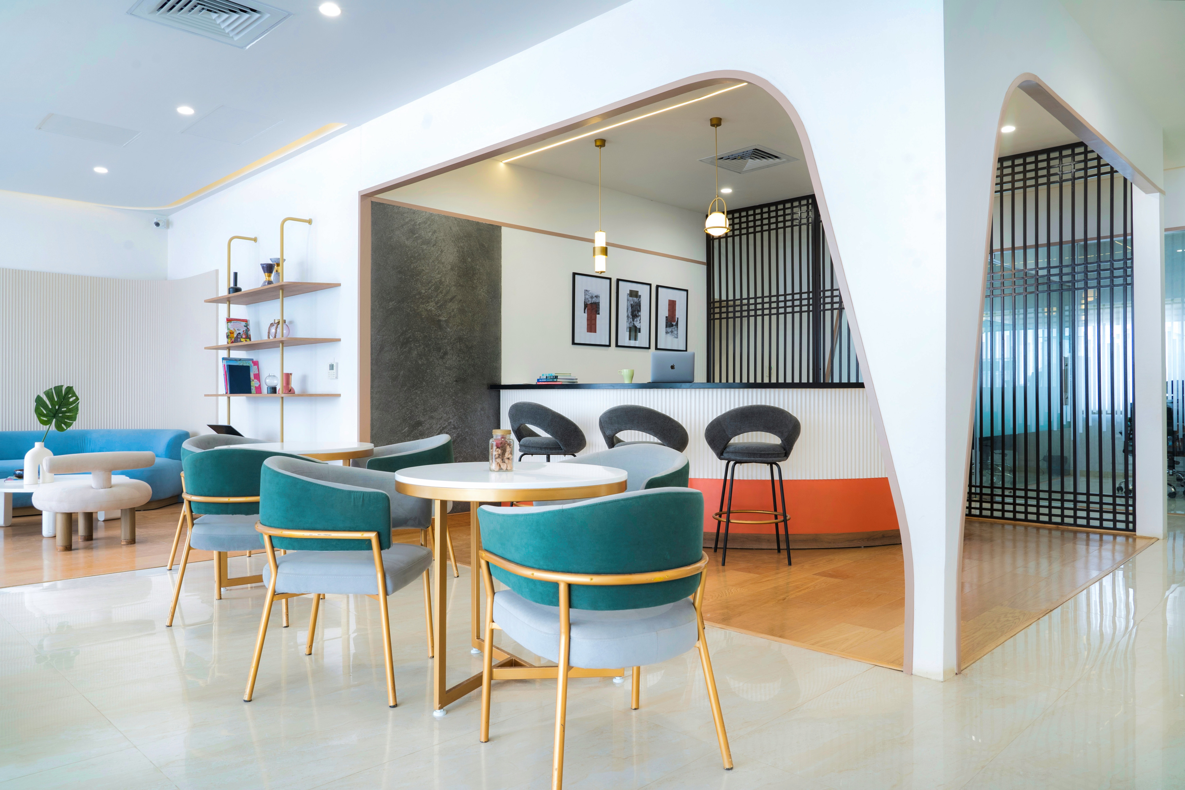 Café seating beneath a sculptural arch