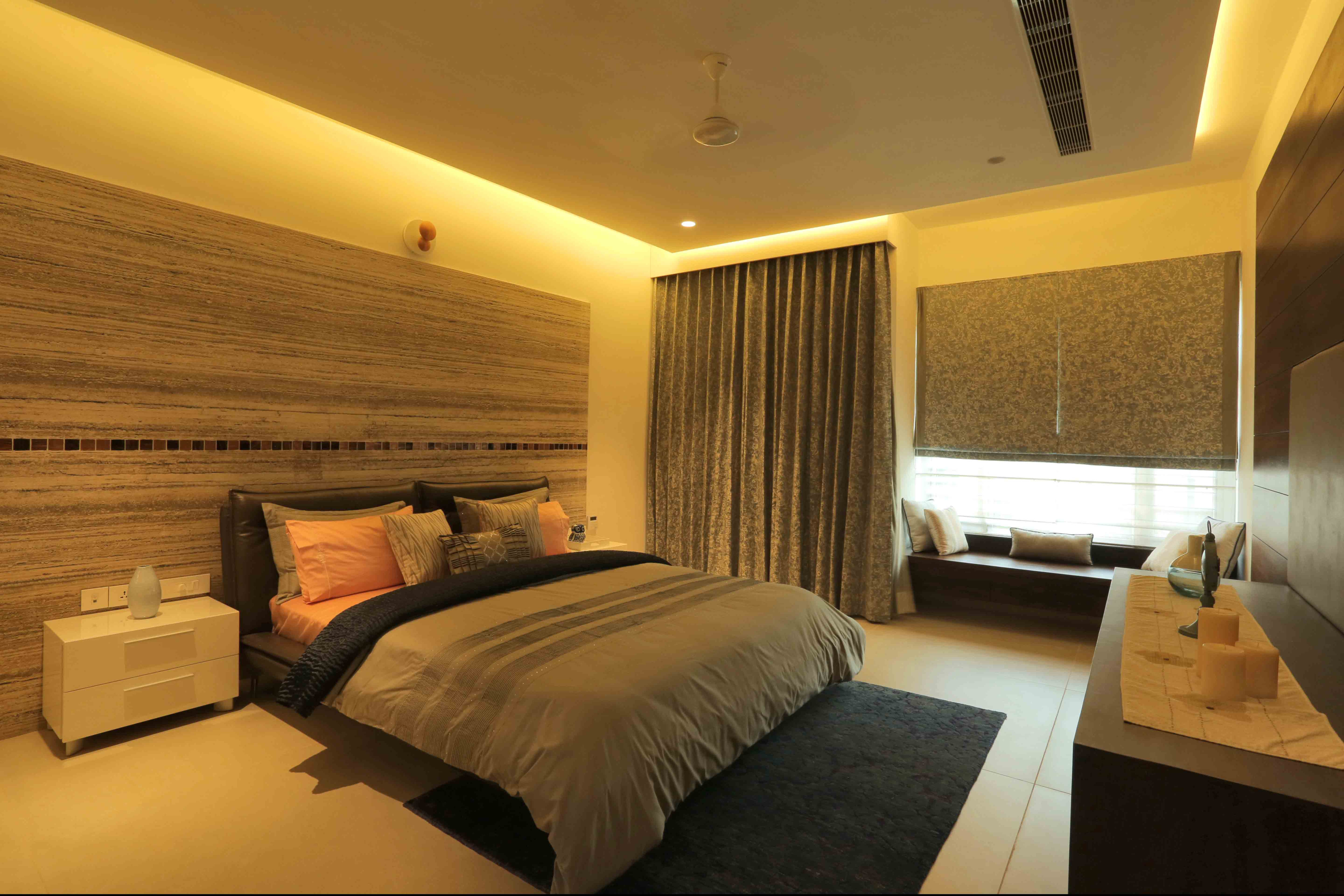 Master bedroom with travertine headboard wall
